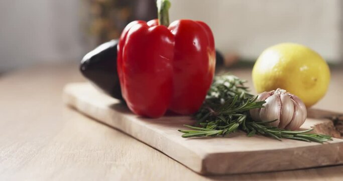 Slide shot of fresh vegetables, eggplant, bell pepper, lemon, garlic and rosemary, 4k prores footage