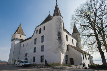 Fototapeta na wymiar Lake Geneva, Switzerland , 3 april 2017 ; Towered White Fairy Tale Castle in Nyon