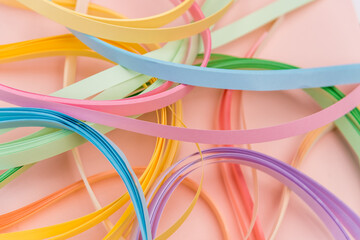 Rainbow colored filigree paper laid out in waves and shapes