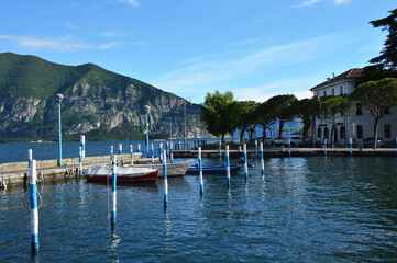 Fototapeta na wymiar ISEO, ITALY - MAY 13, 2017: View of the pier of Iseo Lake with boats, Iseo, Italy