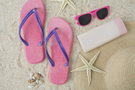 Sandal and beach item on sand