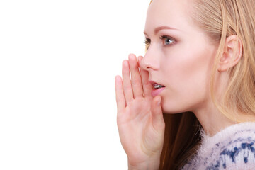 Fototapeta premium Young blonde woman whispering with hand near mouth
