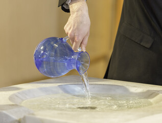 Pouring Water into Baptismal Font