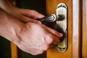 Man hand opening a door