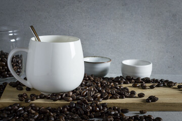 Big cup of coffee with coffee bean on the stone table.