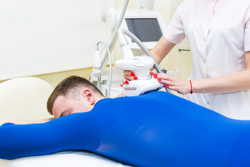 Male is in the process at the clinic lipomassage 