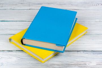 Colorful books on white wooden table. Copy space for text. Back to School.