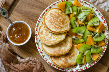 Pancakes with kiwi mandarins and jam for breakfast