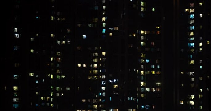 Abstract time lapse of apartment block at night.
