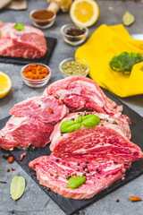 Top view raw pork steak and garlic, pepper on wooden background. Fresh meat