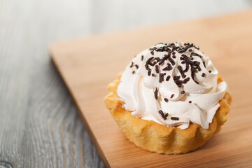 A small cake on a wooden table.