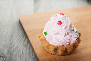 A small cake on a wooden table.
