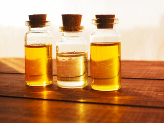 bottle of aroma essential oil or spa or natural fragrance oil with on wooden table, spa or alternative meditation aroma