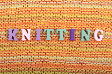 Knitting. Knitted Fabric Texture. Word composed from ABC alphabet letters.