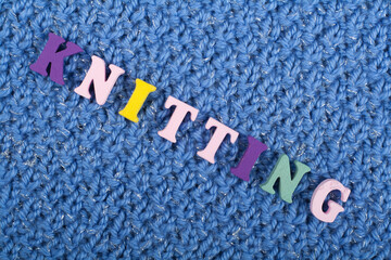 Knitting. Blue Knitted Fabric Texture. Word composed from ABC alphabet letters.