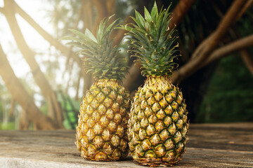 Pineapple fruits on wooden surface