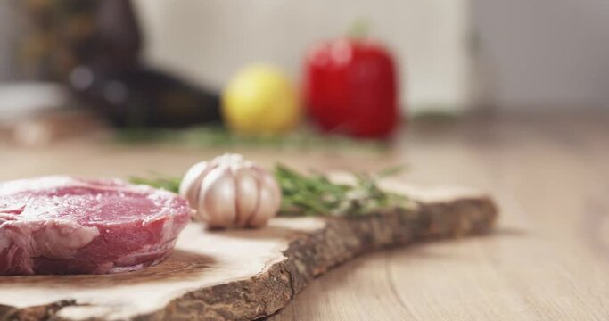Slide slow motion shot of raw rib eye steak on board, 4k 60fps prores footage