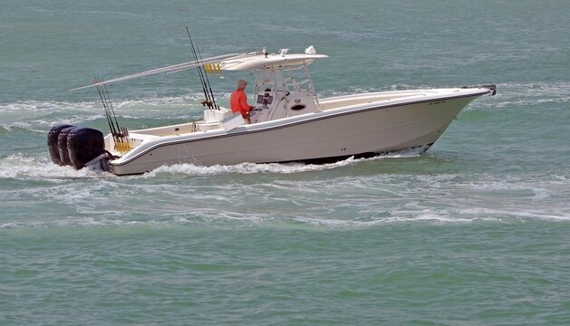 Fototapeta Fishing boat powered bt three outboard engines cruising on the florida intra-coastal waterway off Miami Beach.