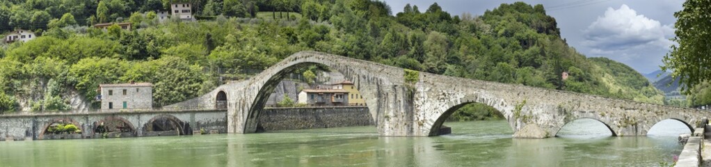 Fototapeta na wymiar panorama with old bridge with arch's on the river in Italy