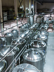 Long rows of tanks made of food grade stainless steel.