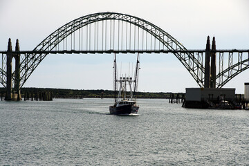 Fishing troller passes under the Yaquina Bay Bridge
