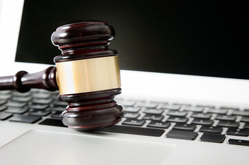 Wooden gavel on laptop keyboard