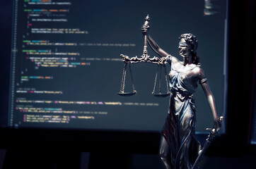 Fototapeta na wymiar Justice statue with code on monitor device in background