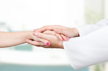 Doctor holding patient hand close up