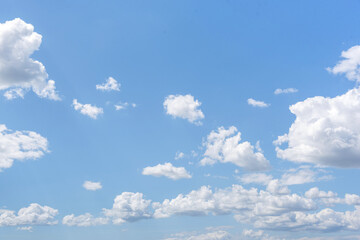 White clouds on the blue clear sky.