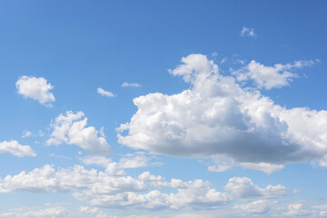 Naklejka na ściany i meble White clouds on the blue clear sky.