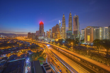 Naklejka na ściany i meble Aerial view of Kuala Lumpur city skyline during blue hour dawn