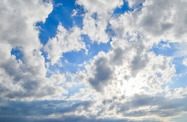 Blue sky with white and grey clouds.