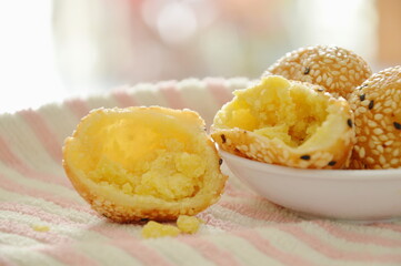 fried glutinous ball topping sesame stuffed mushed yellow bean on cup