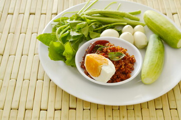fried crispy catfish in chili paste sauce eat with salty egg and fresh vegetable