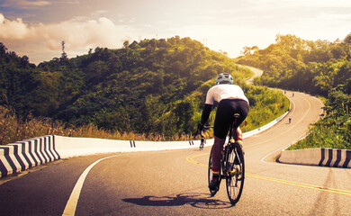 Men cycling mountain road bike in the morning