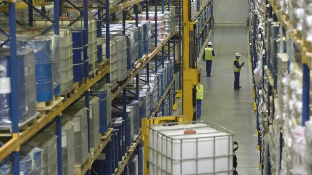 Top view of people and machinery working in modern warehouse