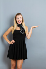 Fototapeta premium Young woman with a displaying hand gesture
