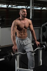 Plakat Muscular Man After Exercise Resting In Gym