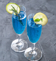 blue curacao cocktail with rosemary, lime and lemon