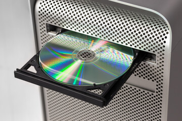 DVD CD ROM on a computer opened to show disc - obrazy, fototapety, plakaty