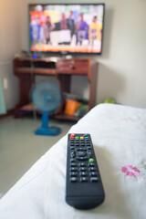 TV remote control with a television as background