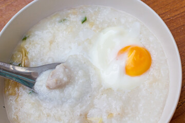 Pain rice porridge with boiled egg for breakfast