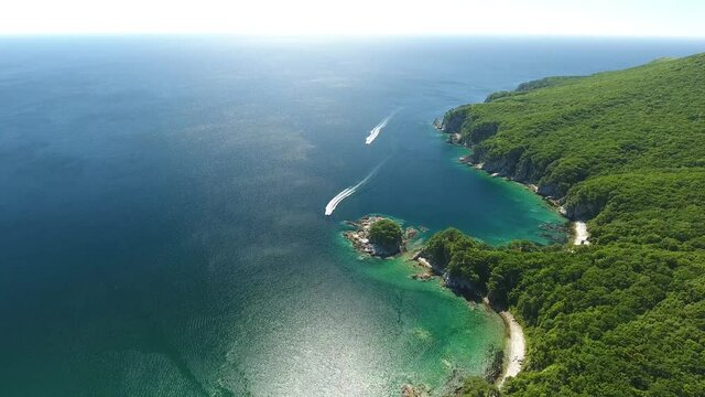 Vityaz panorama Island of Languishing Heart. Speed boats with tourists. Far East Marine Reserve Primorsky Krai Vladivostok Russia. Unique National park Japan Sea. Aerial Helicopter Drone flight.