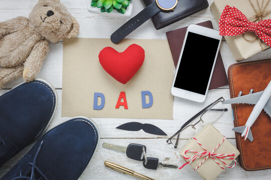 Top view Happy Father day with travel concept.Red heart and word "DAD with paper on rustic wooden background. 