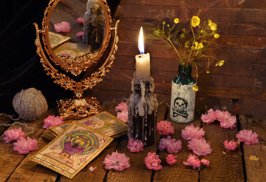 Vintage still life with the tarot cards, flowers and candle