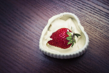 Strawberries in cream in the form of heart