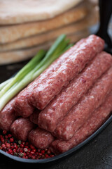 Close-up of raw fresh cevapi or skinless sausages, selective focus, shallow depth of field