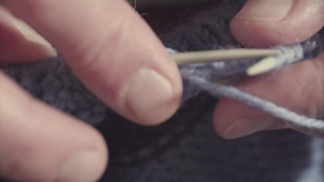 Hands knitting woolen sweater
