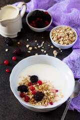 Healthy breakfast. Homemade yoghurt with granola, currant and black raspberries.