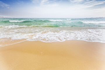 Fototapeta na wymiar Soft Blue Ocean Wave On Sandy Beach. Background. Selective focus.